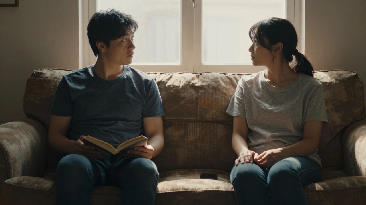 Two people sitting quietly together on a couch, sharing silent companionship in soft sunlight.